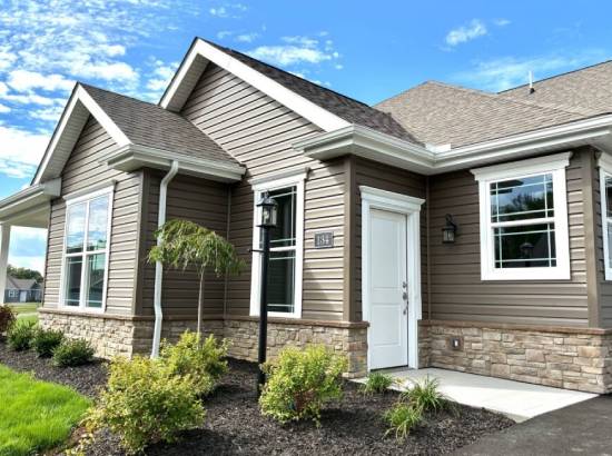 134independencedr105a | Pitell Homes A house featuring brown siding complemented by white trim showcasing a classic and inviting exterior design